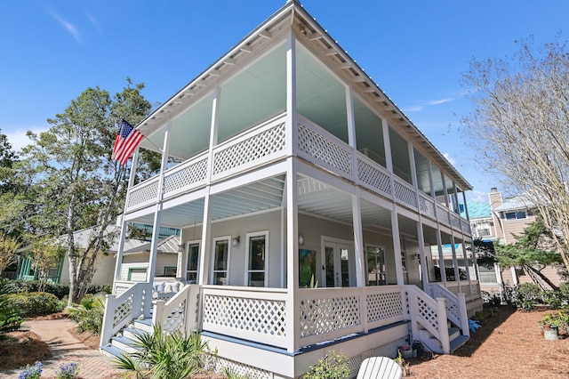 view of home's exterior with a porch and a balcony