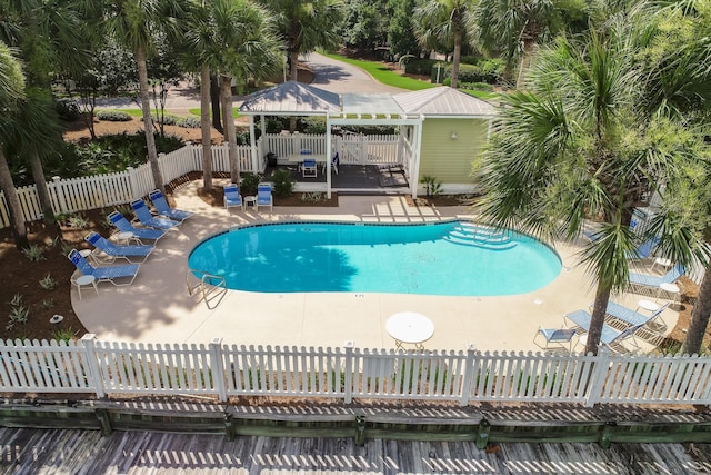 pool featuring a fenced backyard, a patio, and a gazebo