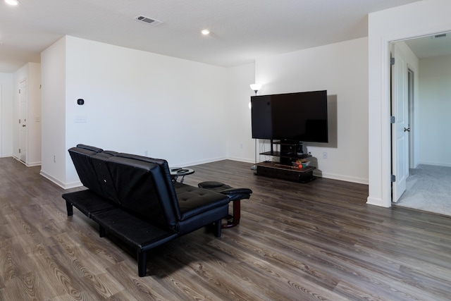 living room featuring baseboards, visible vents, and dark wood-style flooring