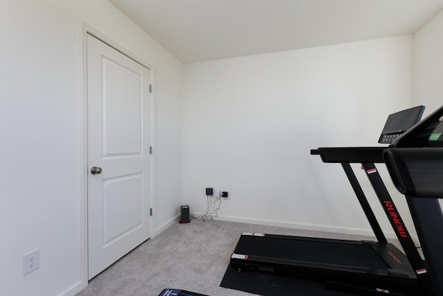 workout room with carpet floors and baseboards