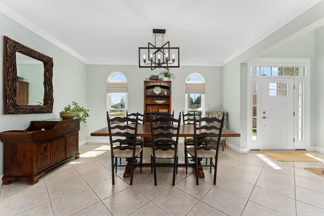 dining room featuring light tile patterned floors, an inviting chandelier, baseboards, and crown molding