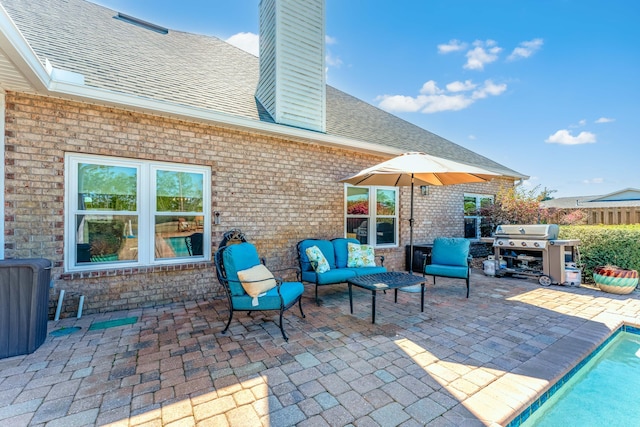 view of patio featuring fence, area for grilling, and an outdoor hangout area