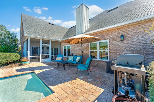 view of patio / terrace with area for grilling, a sunroom, and an outdoor pool