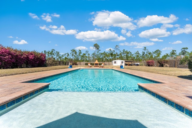 view of pool featuring a patio, a lawn, fence, and a fenced in pool