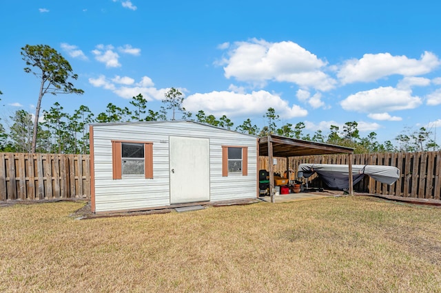 view of shed with a fenced backyard and a carport