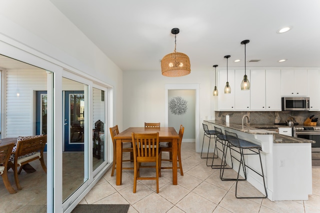 dining area featuring light tile patterned floors, baseboards, visible vents, and recessed lighting