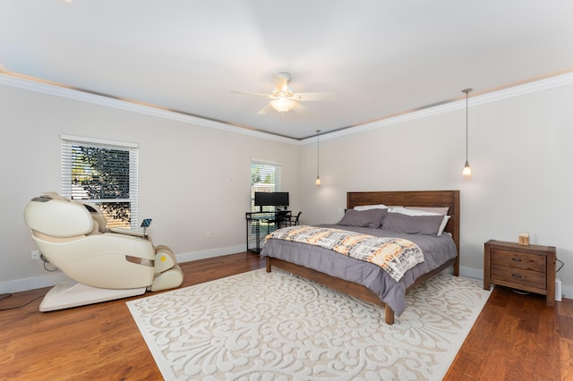 bedroom featuring crown molding, baseboards, and wood finished floors