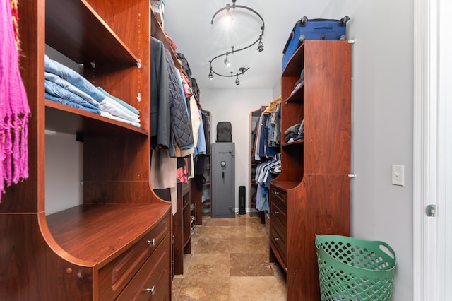 spacious closet with stone finish flooring