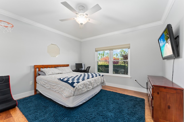 bedroom with baseboards, wood finished floors, and ornamental molding