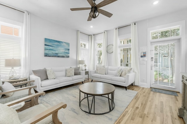 living area with recessed lighting, plenty of natural light, light wood-style flooring, and a ceiling fan