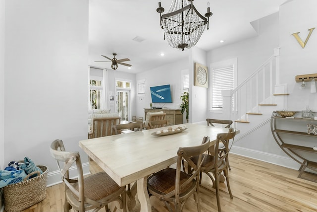 dining space with a wealth of natural light, baseboards, and light wood finished floors