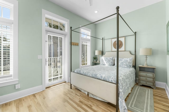 bedroom featuring access to outside, recessed lighting, wood finished floors, and baseboards