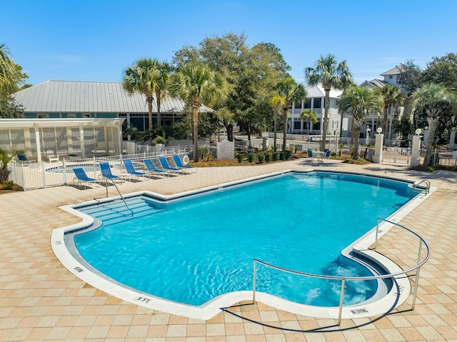 pool featuring a patio and fence