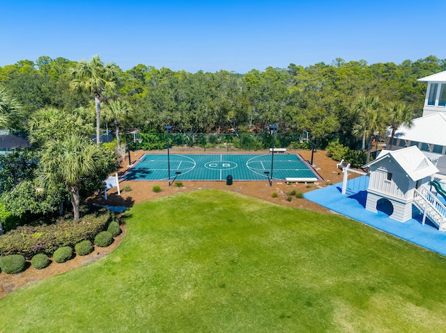 view of swimming pool featuring community basketball court and a lawn