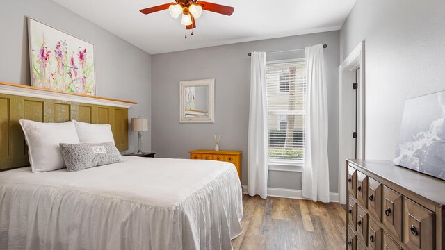 20 N Wildflower Dr Unit 512, Santa Rosa Beach, FL 32459 - bedroom with multiple windows, a ceiling fan, baseboards, and wood finished floors