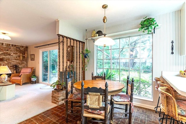 dining area featuring brick floor