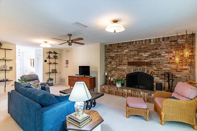 carpeted living room with a ceiling fan, a brick fireplace, and visible vents