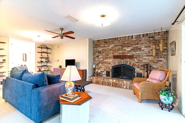 living room with a ceiling fan, a brick fireplace, visible vents, and carpet floors