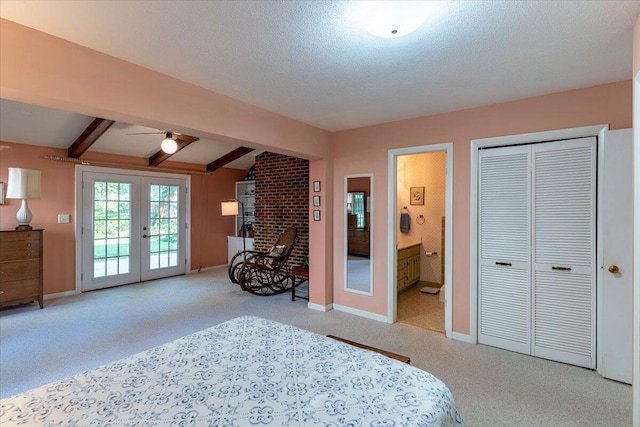 bedroom with access to exterior, french doors, beam ceiling, connected bathroom, and a textured ceiling