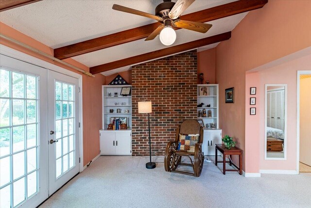 living area with lofted ceiling with beams, brick wall, a textured ceiling, french doors, and carpet floors