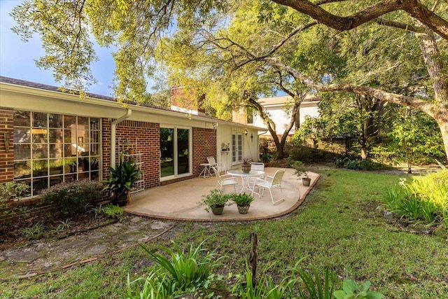 view of yard with french doors and a patio