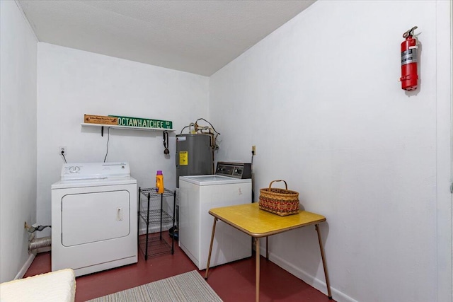 laundry room featuring laundry area, baseboards, electric water heater, and independent washer and dryer