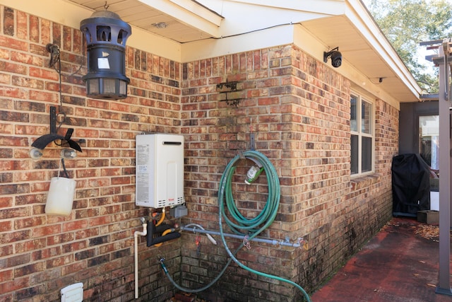 view of home's exterior featuring water heater and brick siding