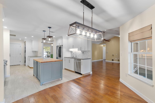 kitchen with wooden counters, dishwasher, decorative backsplash, smart refrigerator, and white cabinetry