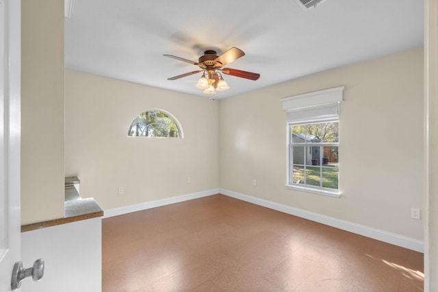 empty room with tile patterned floors, baseboards, and a wealth of natural light