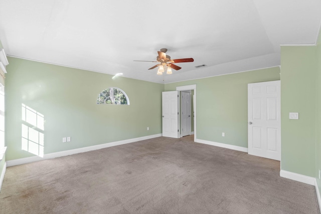 unfurnished room featuring visible vents, baseboards, carpet, and a ceiling fan