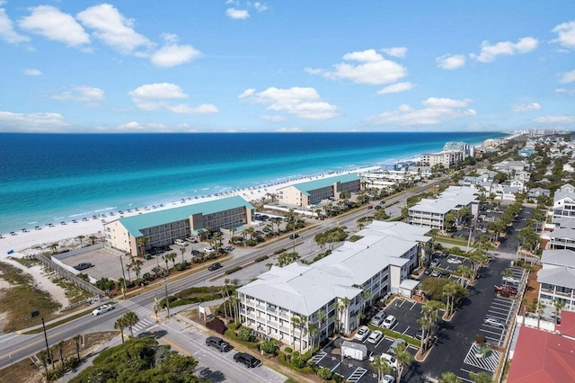 aerial view with a water view and a beach view