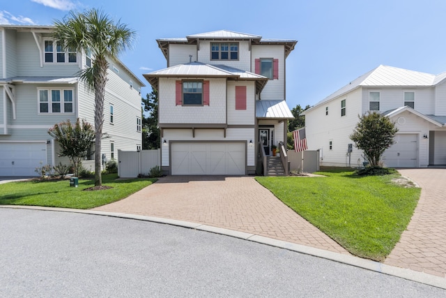 view of front facade featuring a front lawn, metal roof, decorative driveway, and a standing seam roof