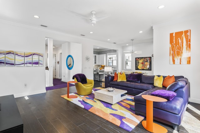 living area featuring wood finished floors, visible vents, recessed lighting, ornamental molding, and ceiling fan