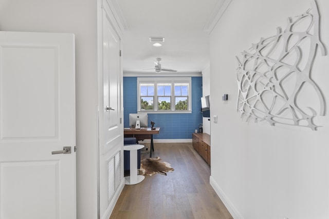 corridor featuring visible vents, wood finished floors, and baseboards