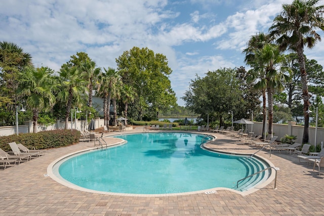 pool featuring a patio and fence