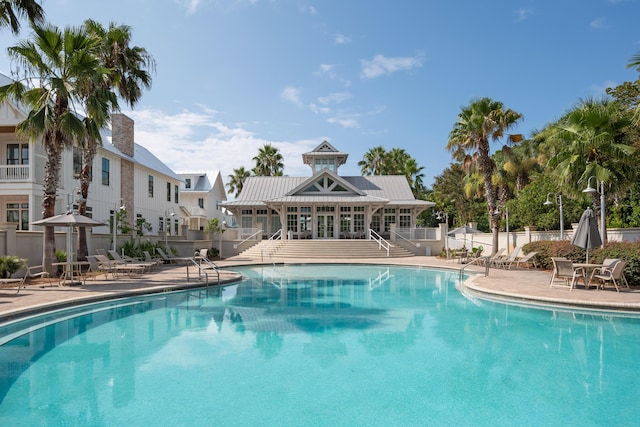 pool with a patio area and fence