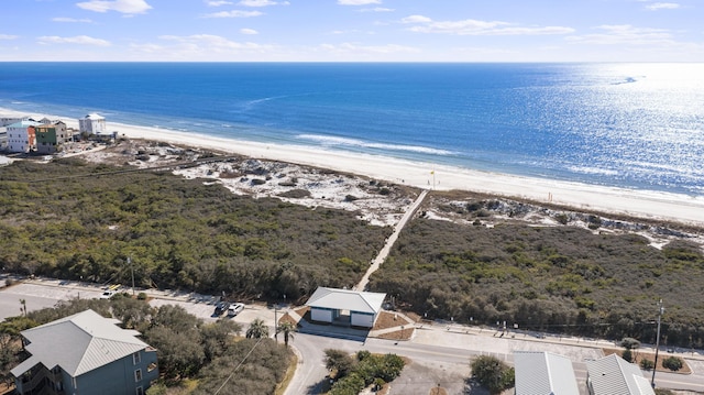 birds eye view of property featuring a beach view and a water view