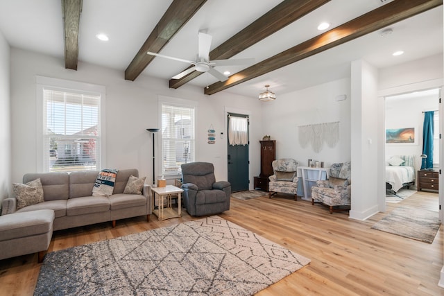 living area with beamed ceiling, recessed lighting, and light wood finished floors