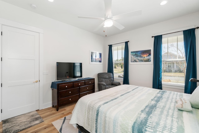 bedroom featuring a ceiling fan, multiple windows, light wood-style floors, and recessed lighting