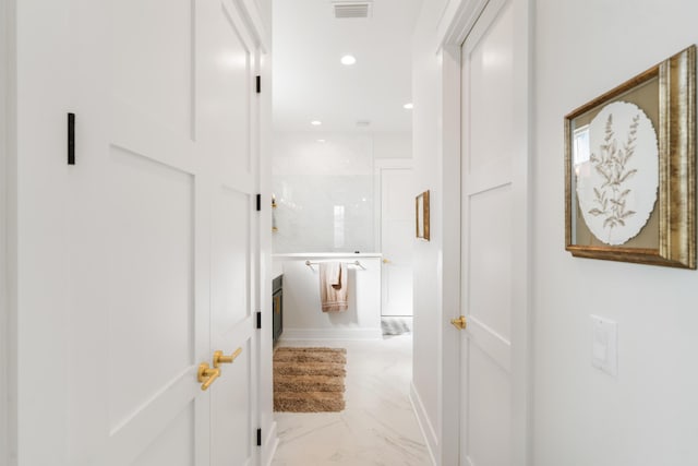 hallway with recessed lighting, visible vents, and marble finish floor