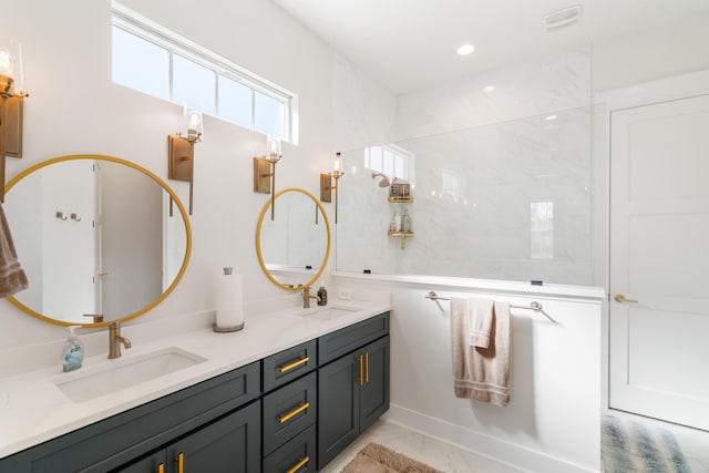 bathroom featuring double vanity, recessed lighting, marble finish floor, and a sink