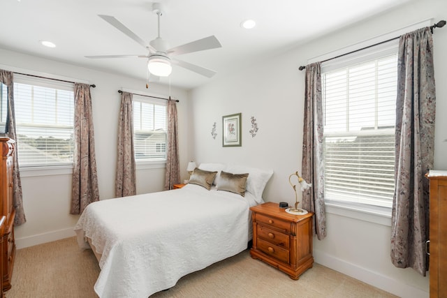 bedroom featuring recessed lighting, light colored carpet, baseboards, and ceiling fan