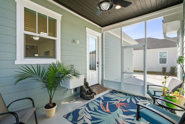 sunroom / solarium featuring wooden ceiling and a ceiling fan