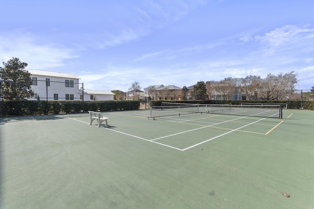 view of tennis court with fence