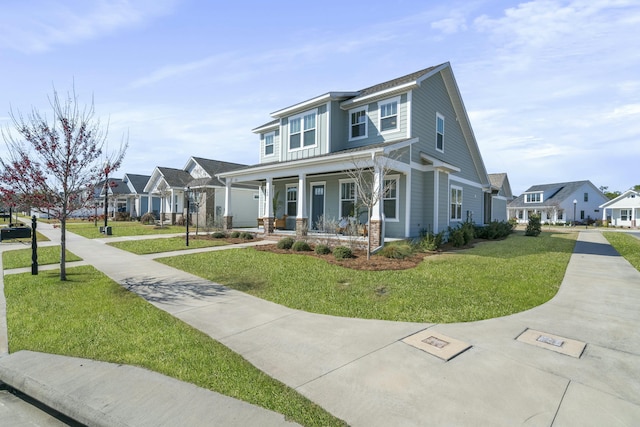 view of front of home featuring a residential view, a porch, and a front lawn