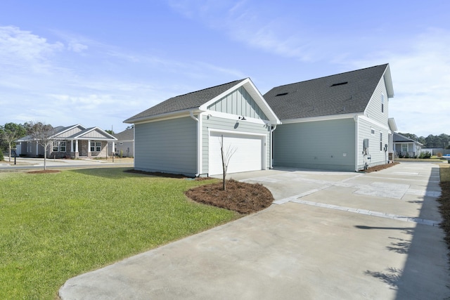 view of home's exterior featuring an attached garage, a shingled roof, concrete driveway, a lawn, and board and batten siding