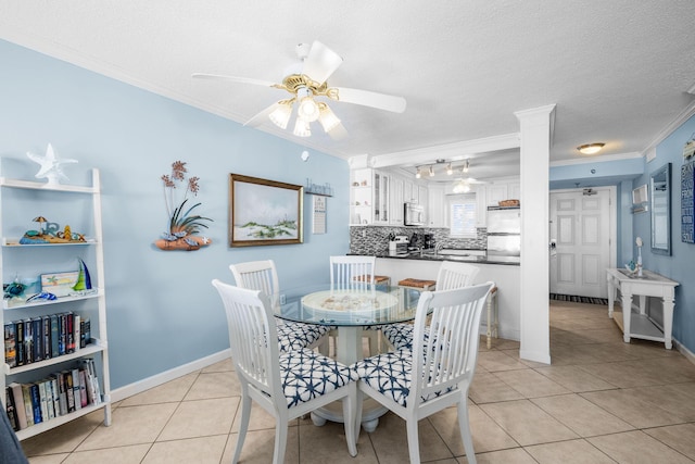 dining space with ceiling fan, ornamental molding, a textured ceiling, and light tile patterned flooring