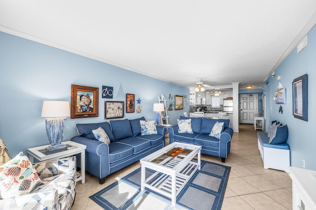 living room with ornamental molding, light tile patterned flooring, and ceiling fan