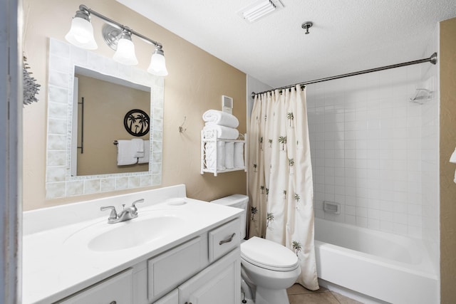 full bathroom with shower / bath combo, toilet, tile patterned floors, a textured ceiling, and vanity