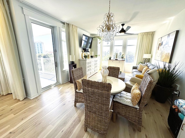 dining area featuring light wood-type flooring and a notable chandelier